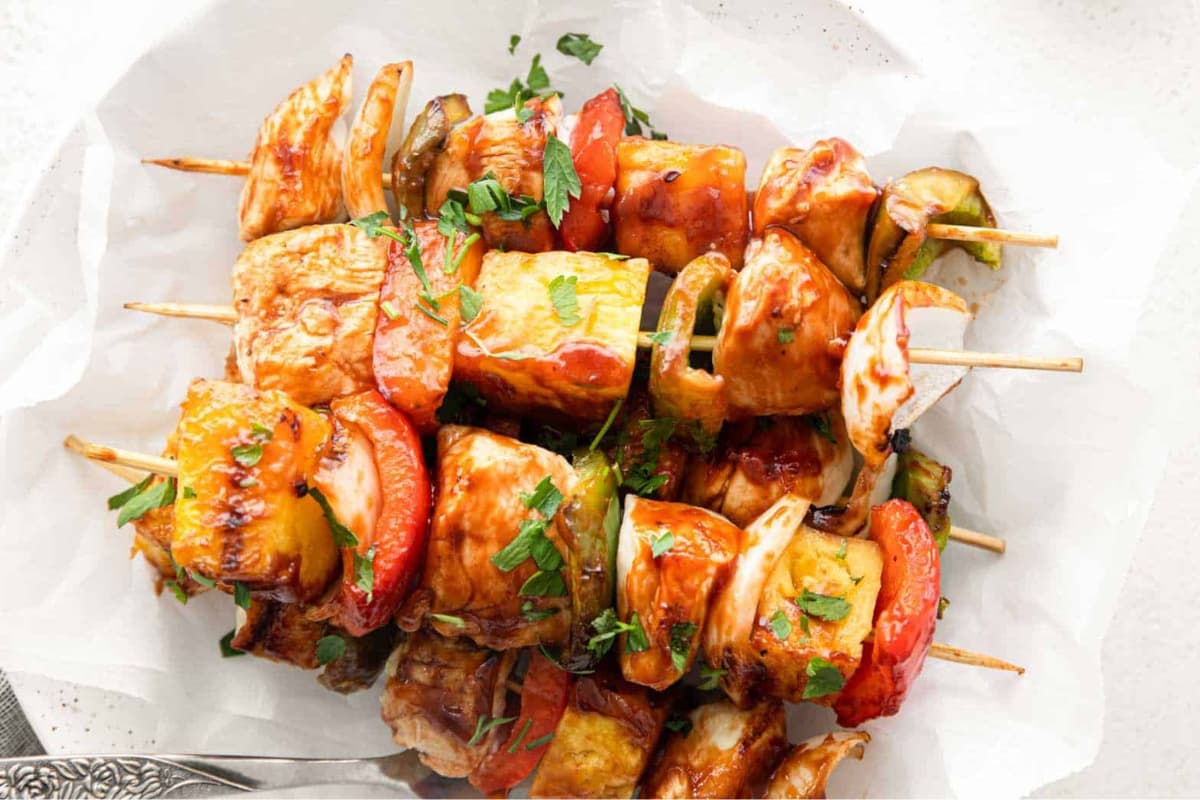 Grilled chicken kabobs on a plate.