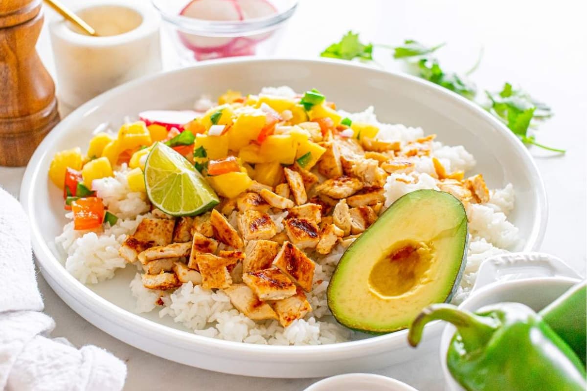 A plate of grilled chicken with pineapple.