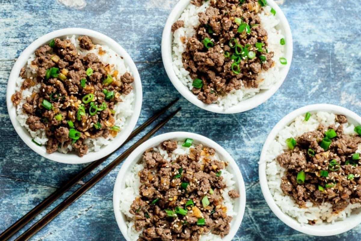 Four Korean beef bowls on a counter.