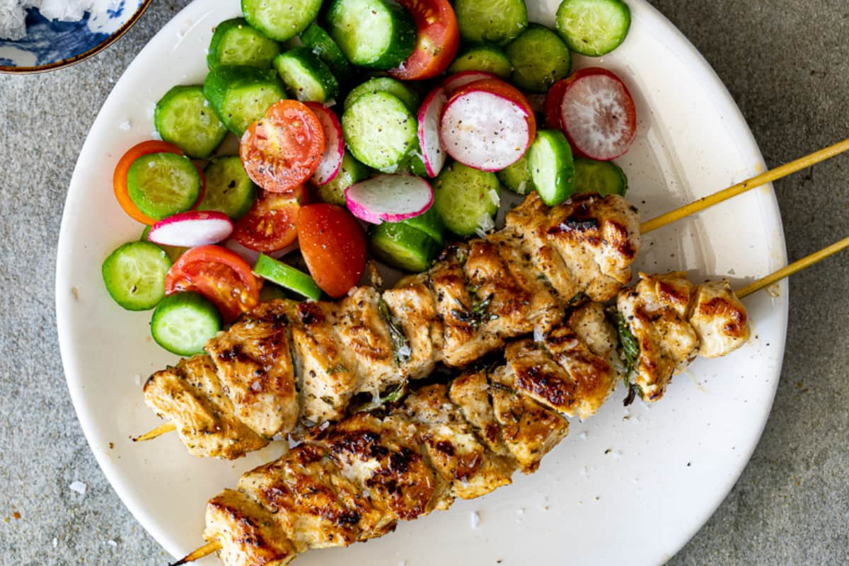 A plate of lemon chicken skewers.