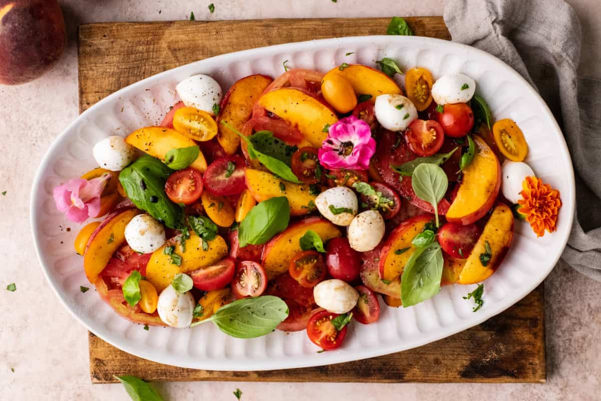 A platter of peach caprese salad.