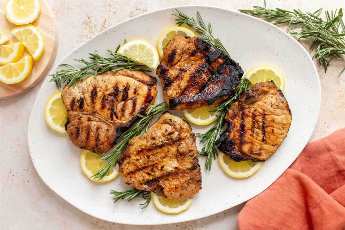 Grilled rosemary porkchops on a plate.