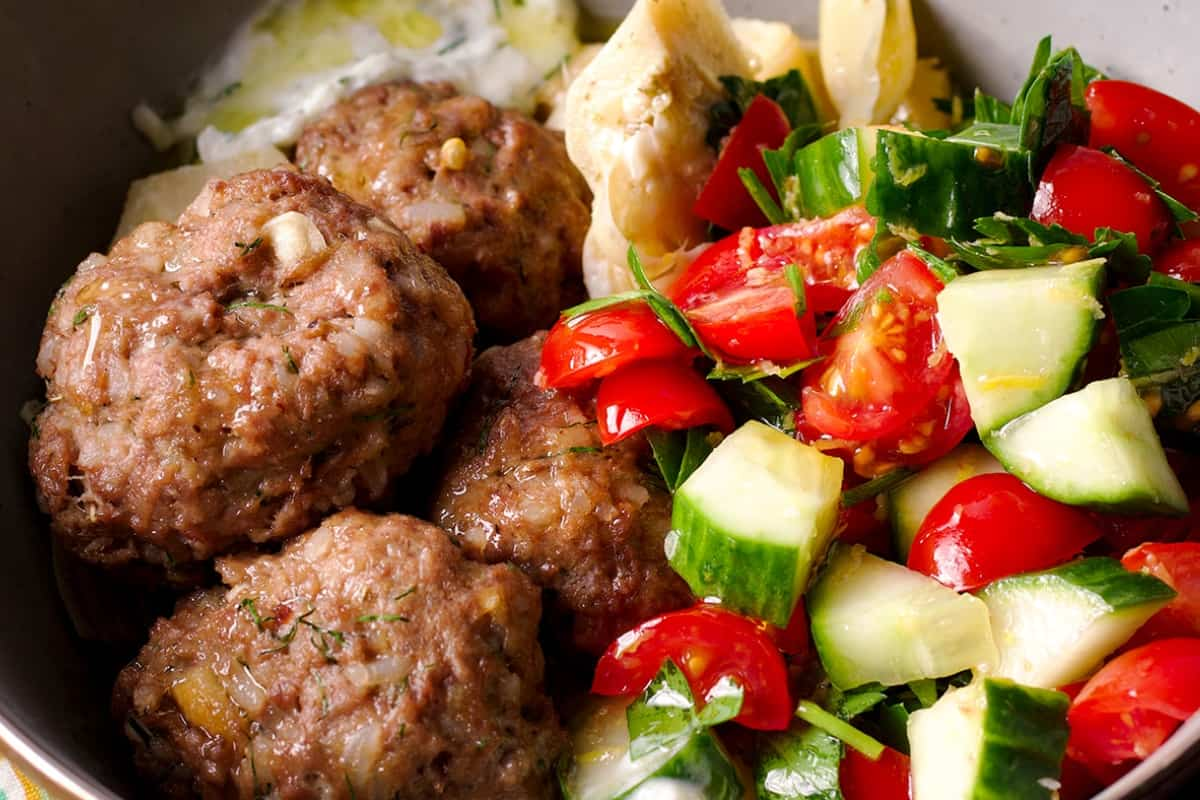 Sheet pan Greek meatballs in a bowl.