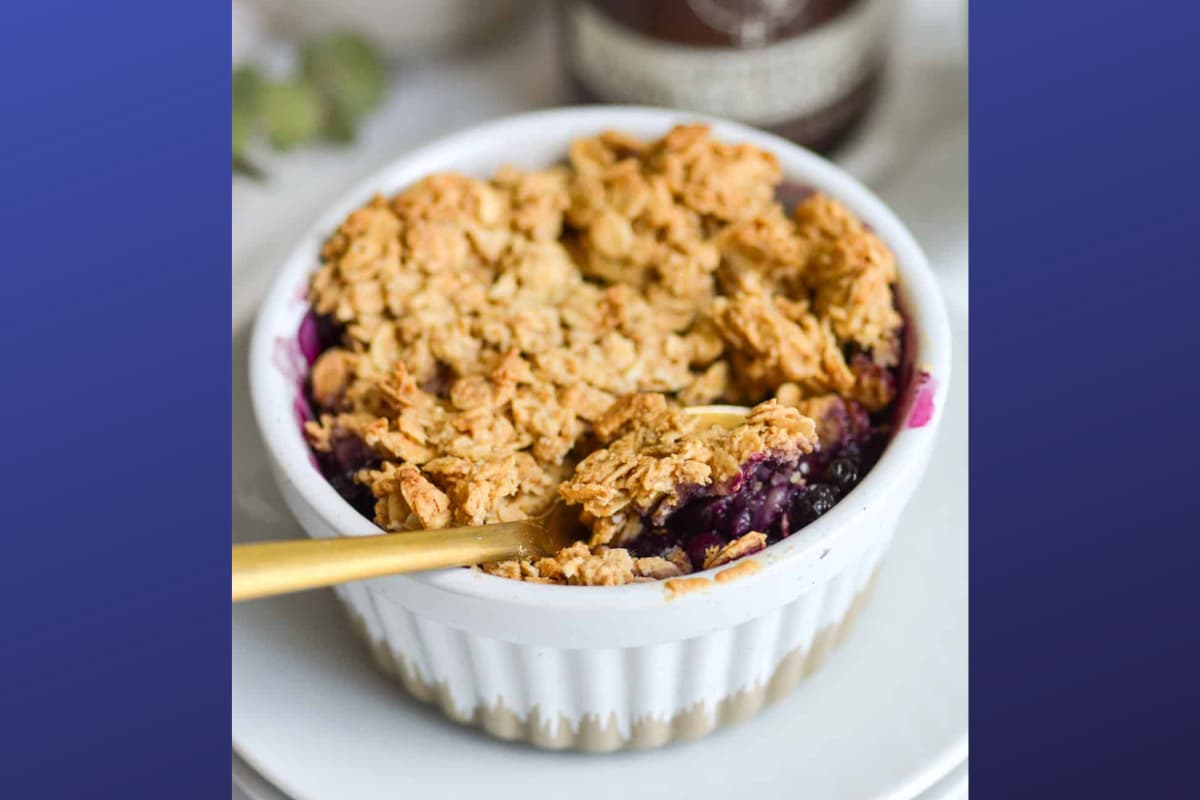 A dish of single serving blueberry crisp.