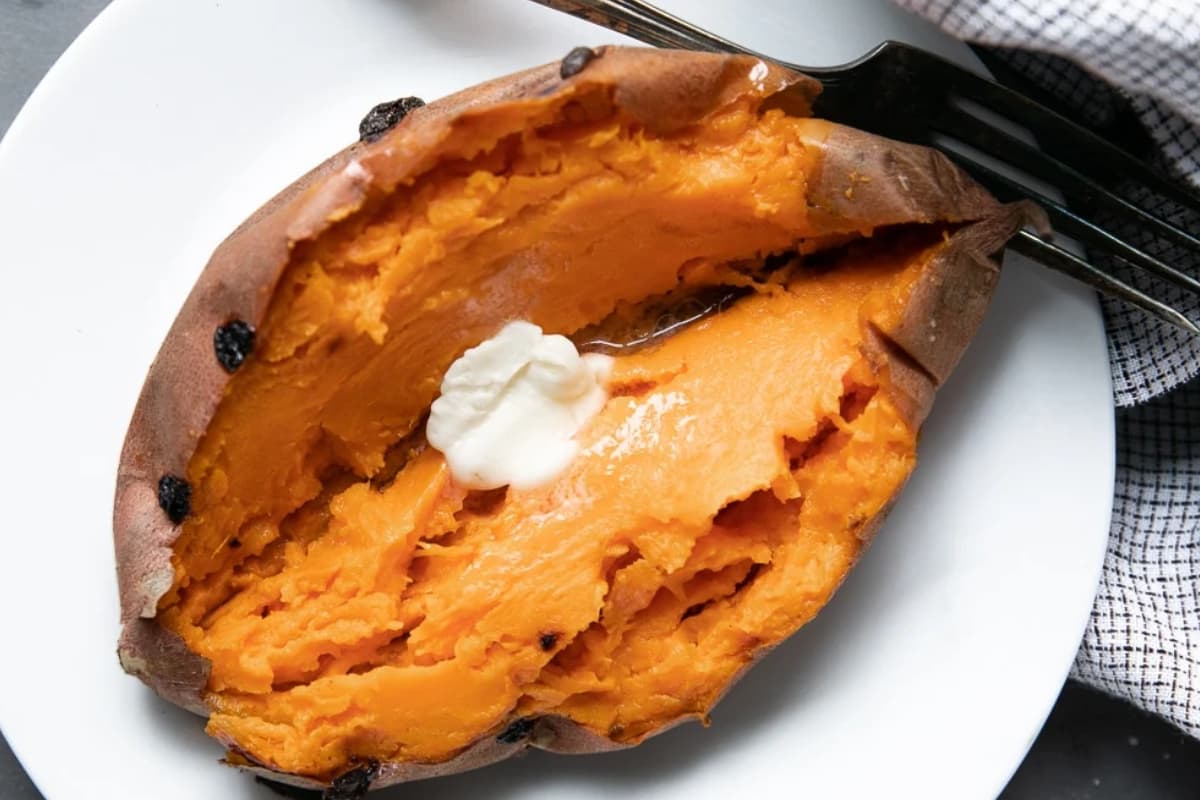 A baked sweet potato on a plate.