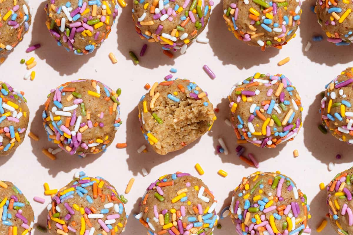 Birthday cake protein balls on a counter.