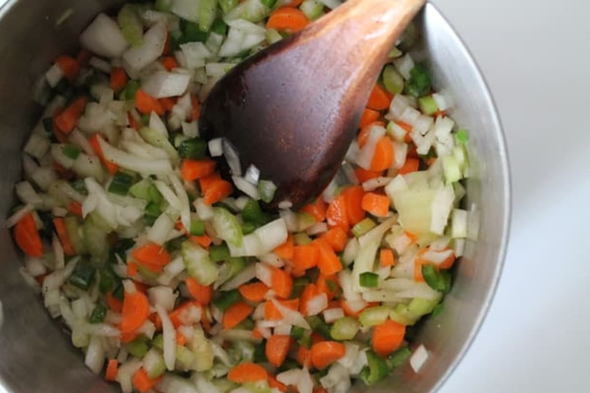 Veggies being stirred in a pot.