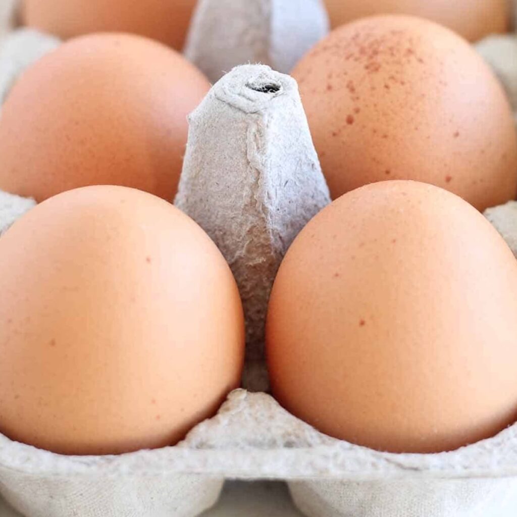 A carton of eggs on a counter.