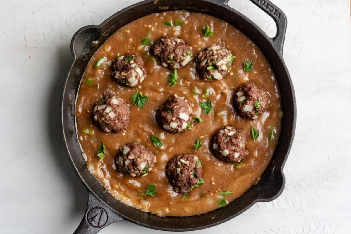 A pan of meatballs and gravy.