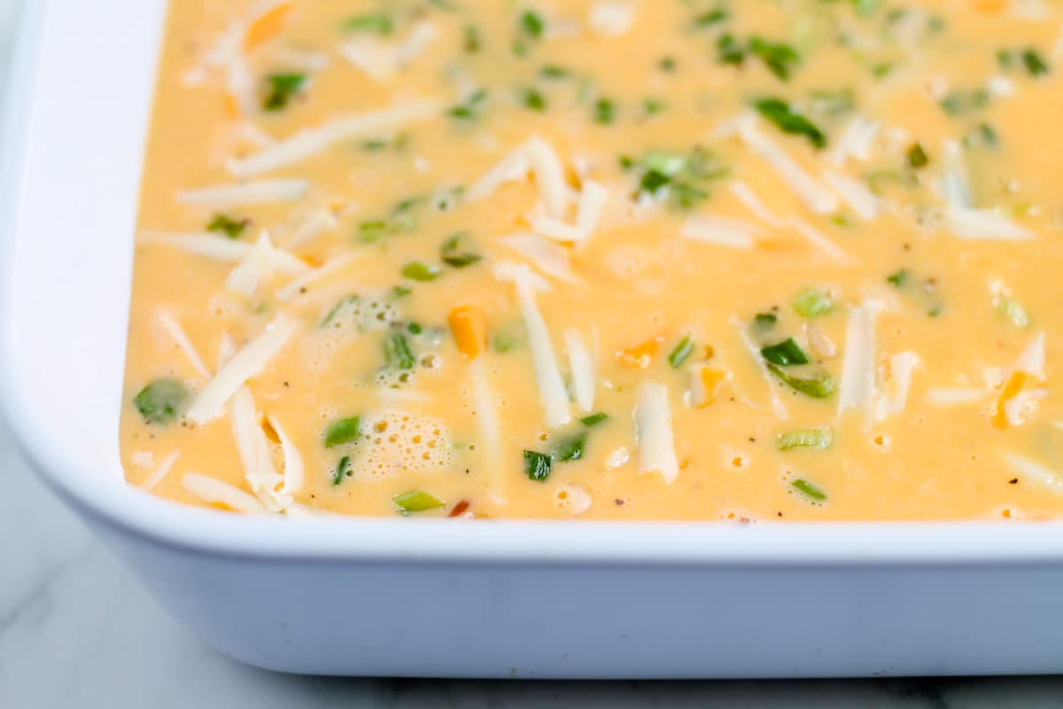 Beaten eggs in a baking dish.