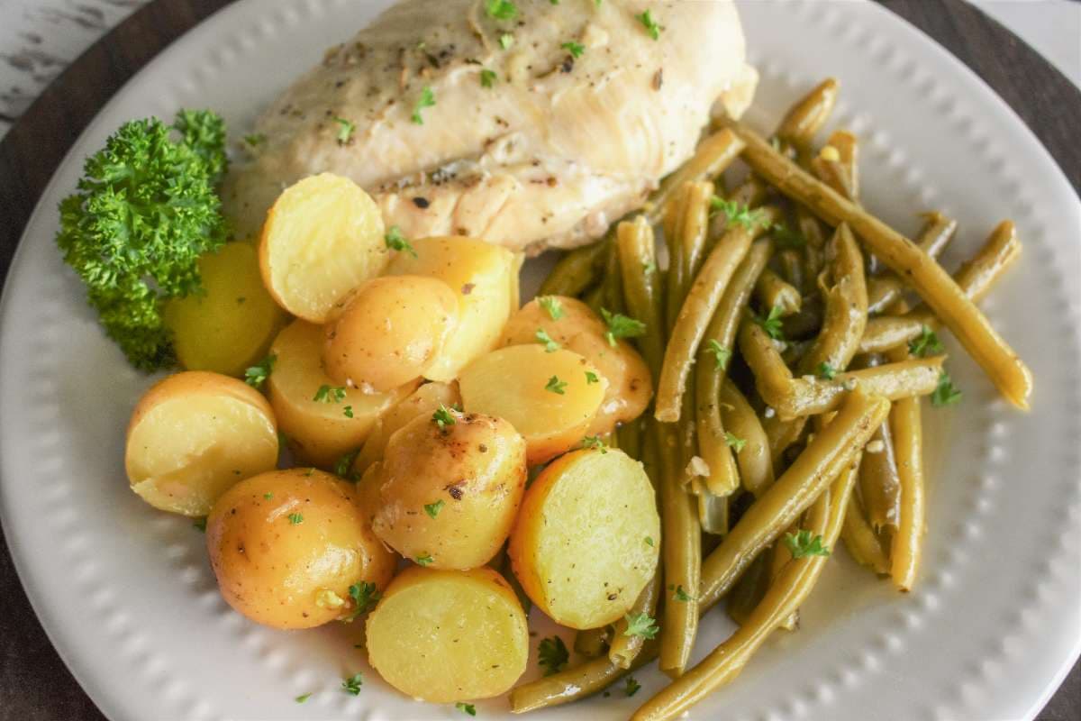 A plate of slow cooker-chicken-potatoes and beans.