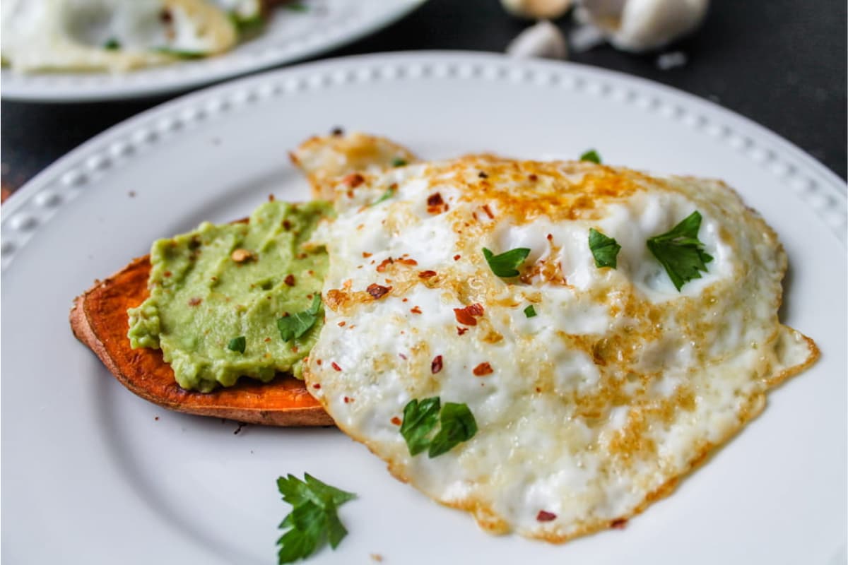 A plate of sweet potato toast with avocado.