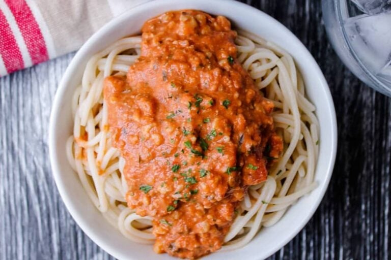 A bowl of pasta topped with walnut "meat" sauce.