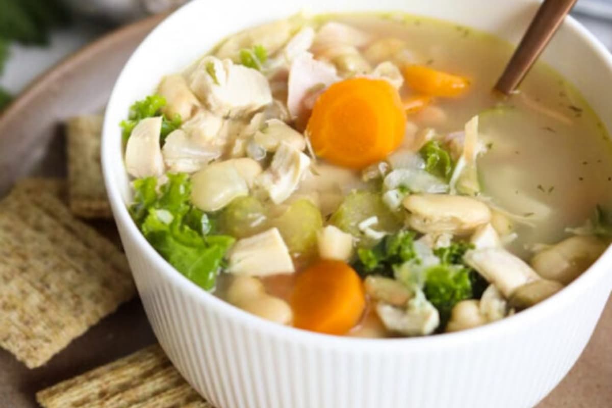 A bowl of white bean and chicken soup.