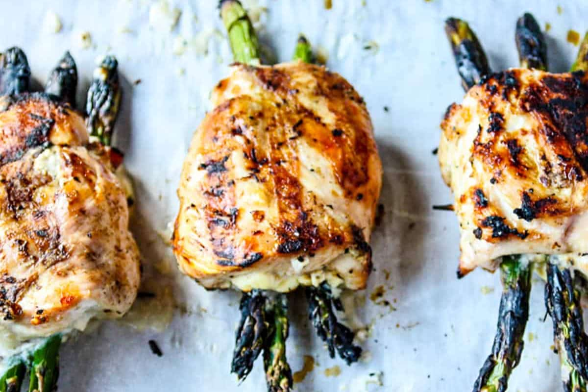 A platter of asparagus stuffed chicken breasts.