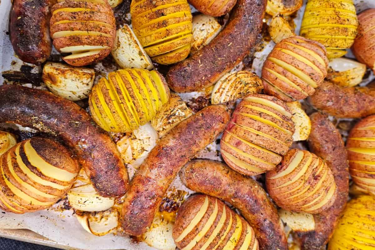 A sheet pan of brats and potatoes.