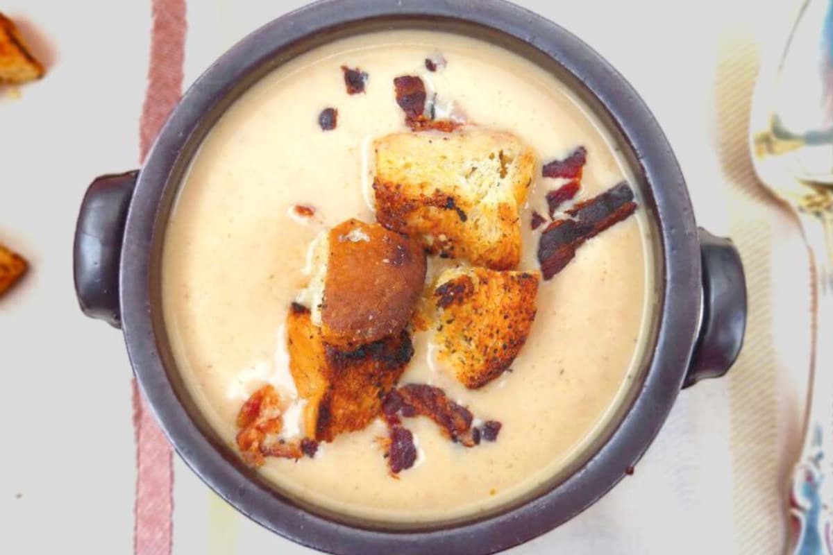 A bowl of cauliflower red pepper soup.