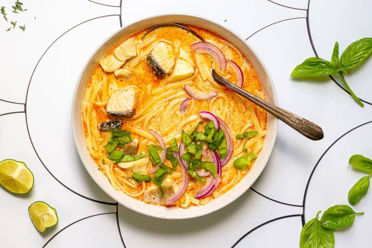 A bowl of fish coconut curry soup.