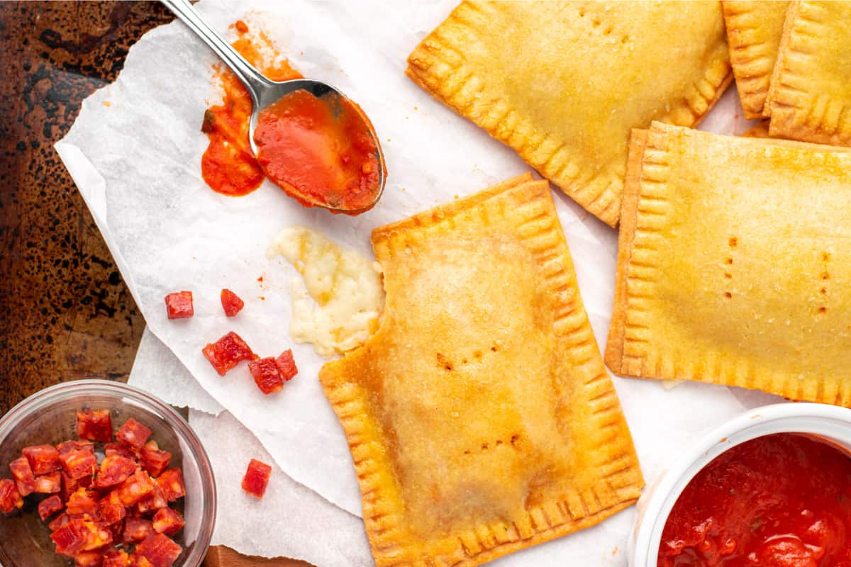 A tray of gluten-free pizza pockets.