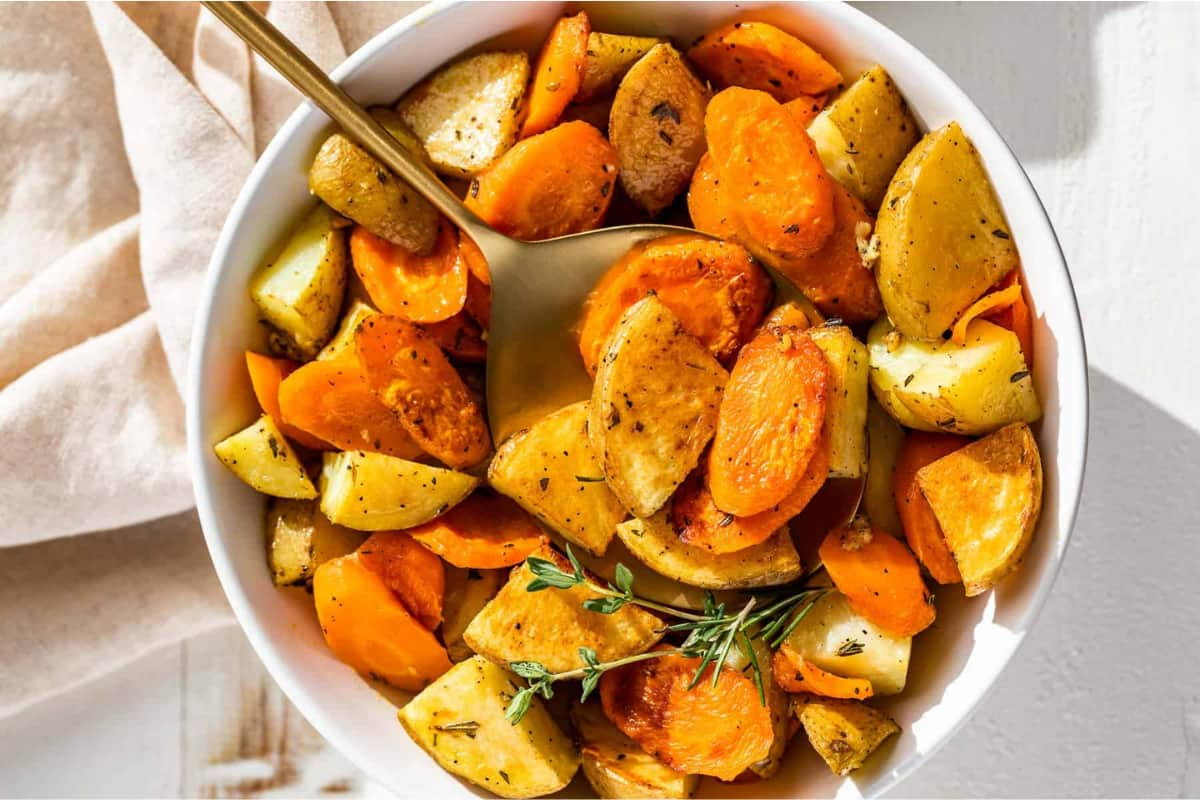 A bowl of roasted potato carrots.