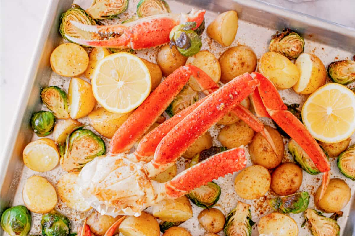 An overhead image of sheet pan crab legs.