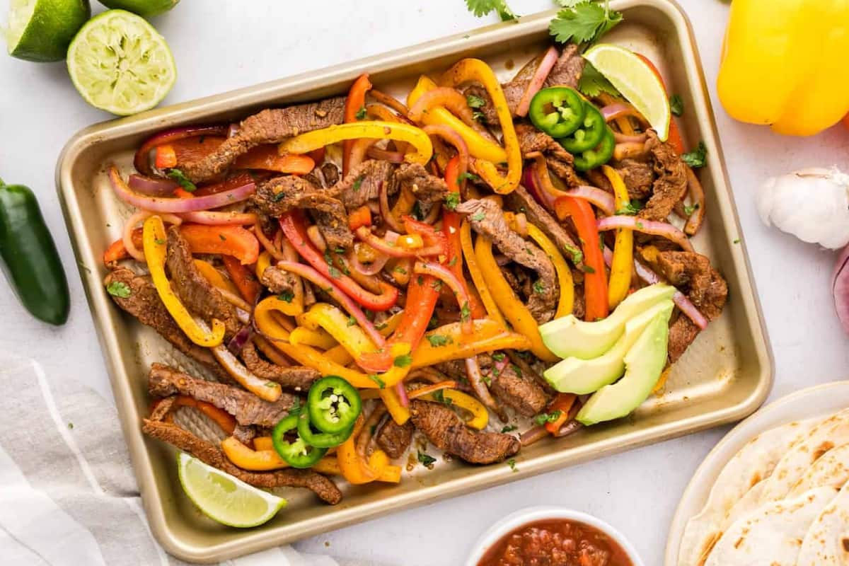 A dish of sheet pan fajitas.