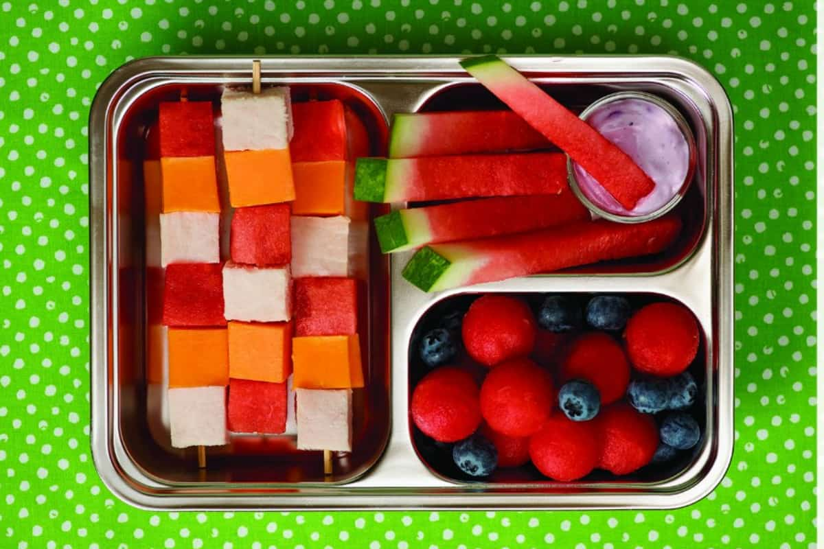 A container of watermelon kabobs.