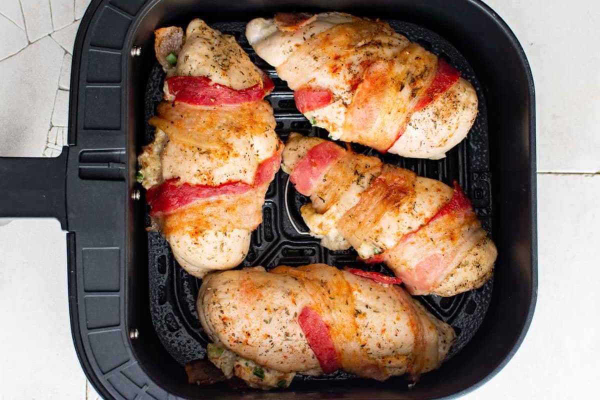 Overhead image of stuffed chicken breast in an air fryer.