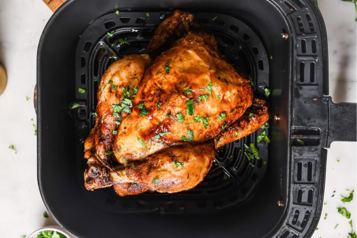 A whole chicken in an air fryer.