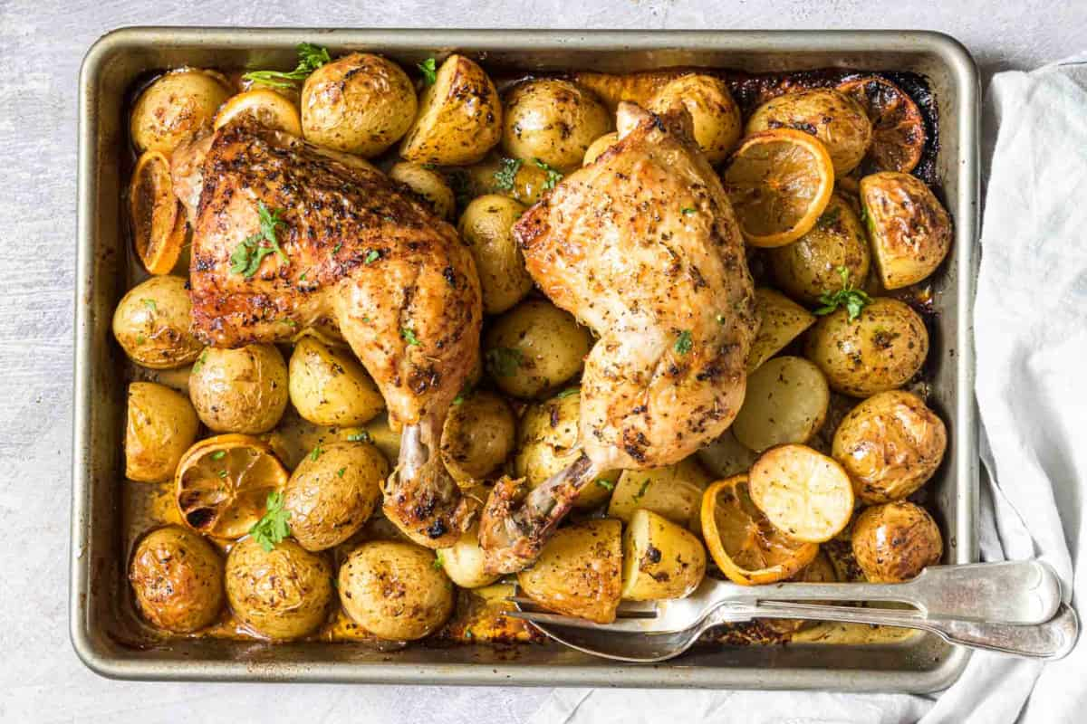 A tray of baked chicken leg quarters.