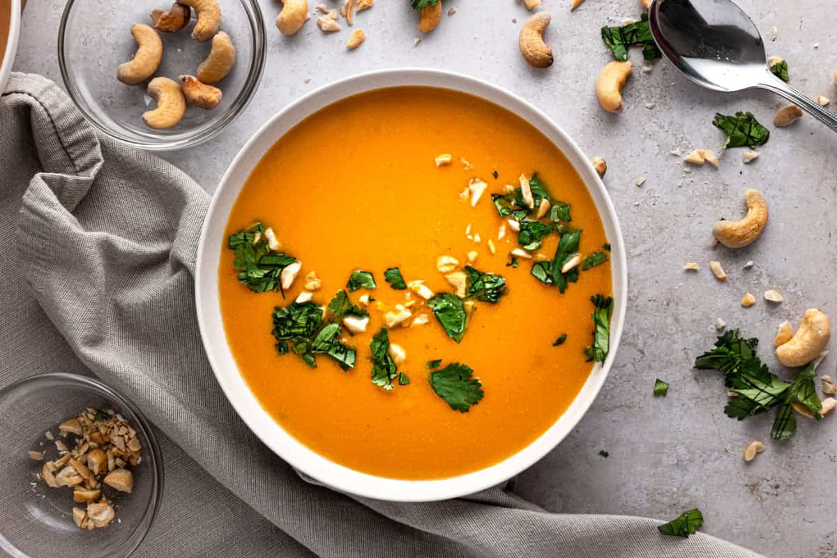 A bowl of cashew carrot ginger soup.