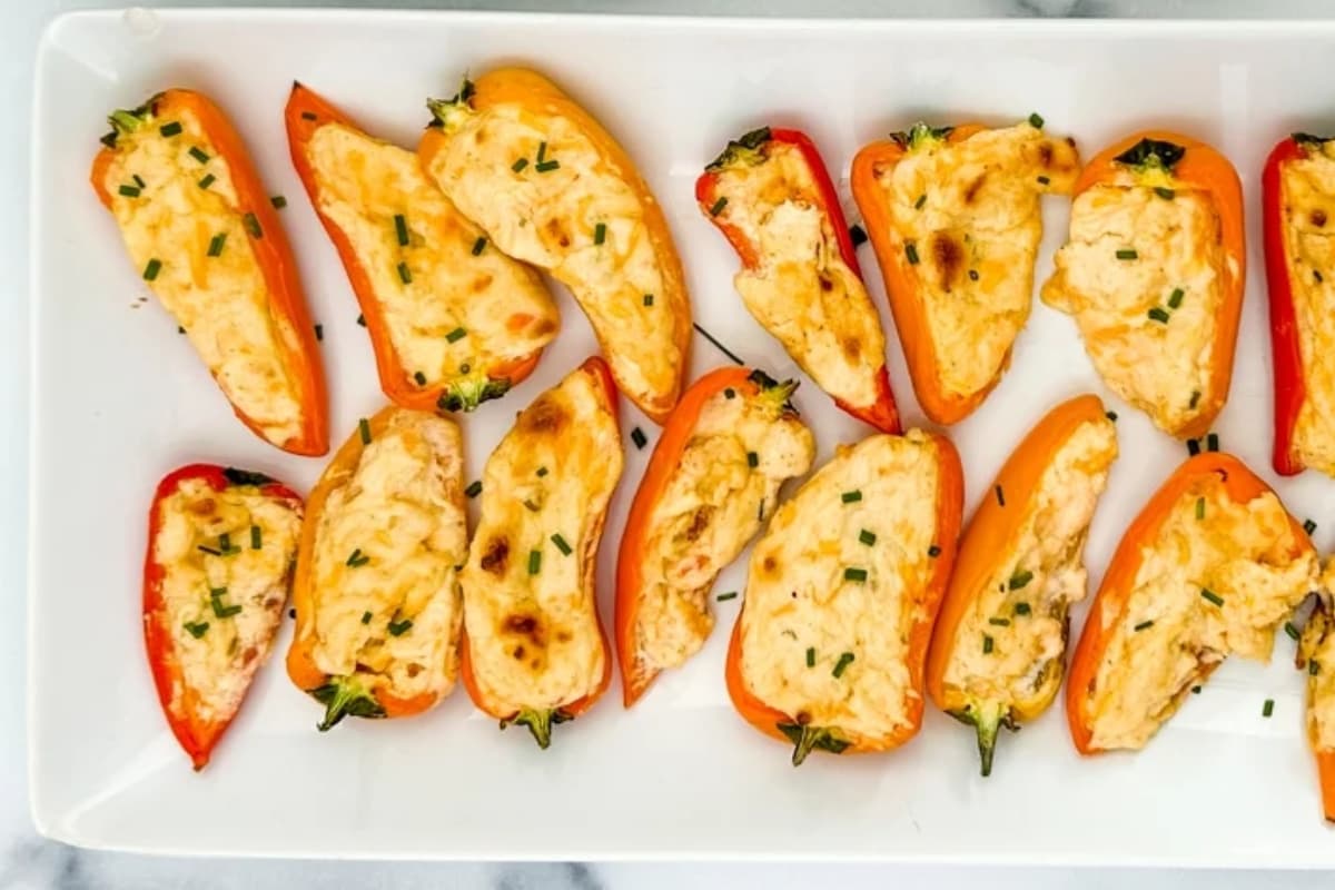 A platter of cream cheese stuffed peppers.