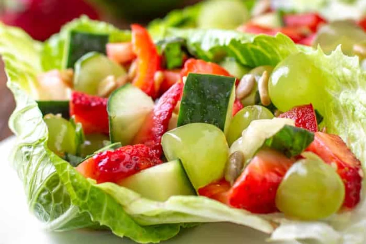 A plate of fruit vegetable salad.