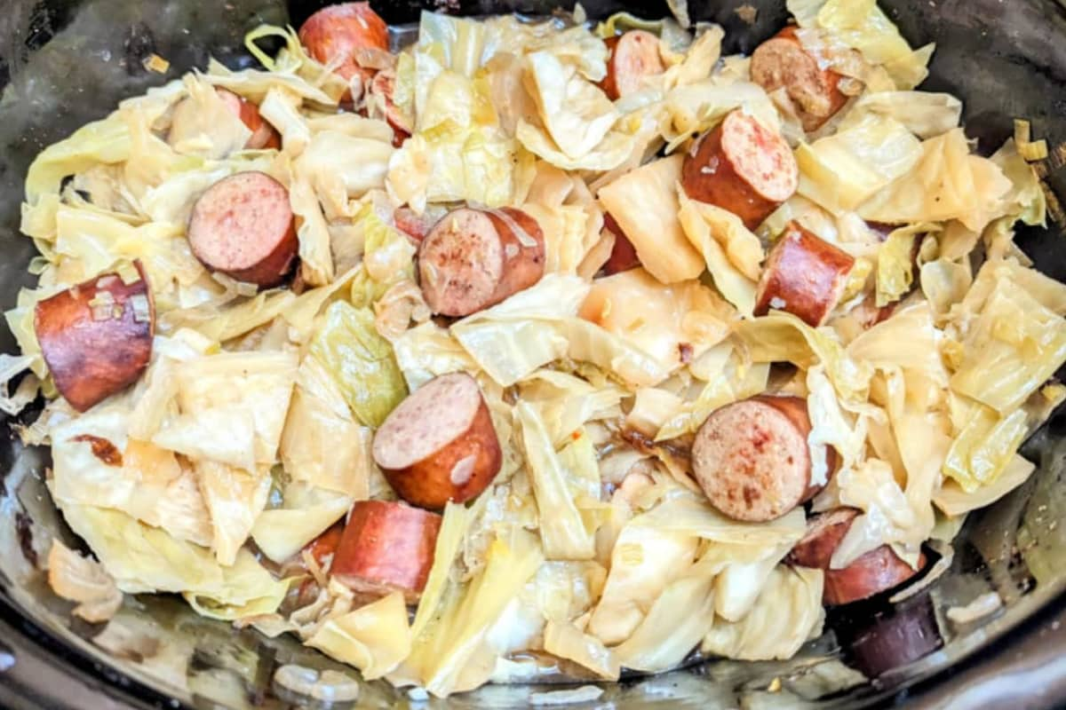 A pot of sausage and cabbage.