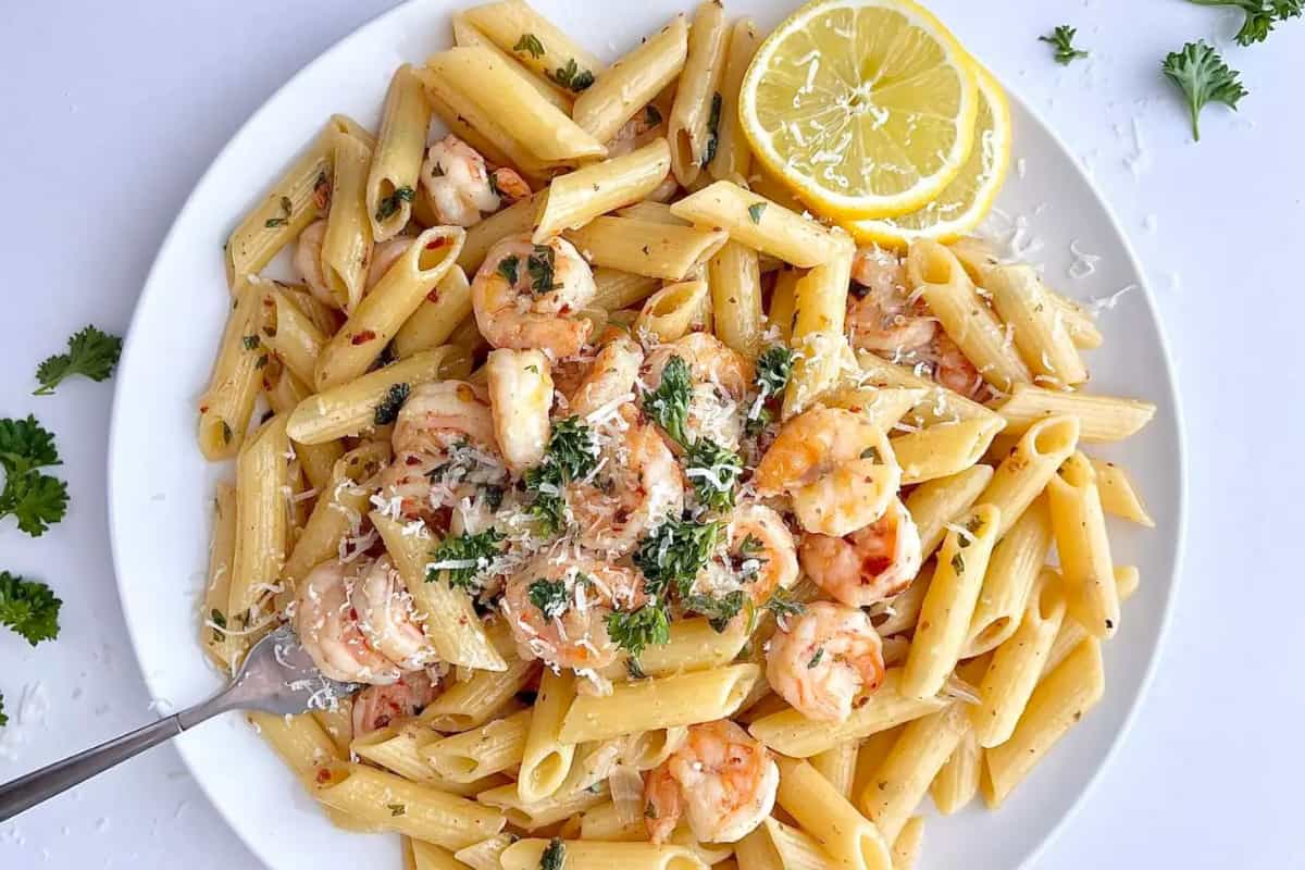 A bowl of shrimp scampi penne pasta.