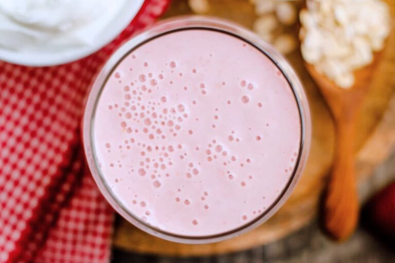 A glass of strawberry oatmeal smoothie.