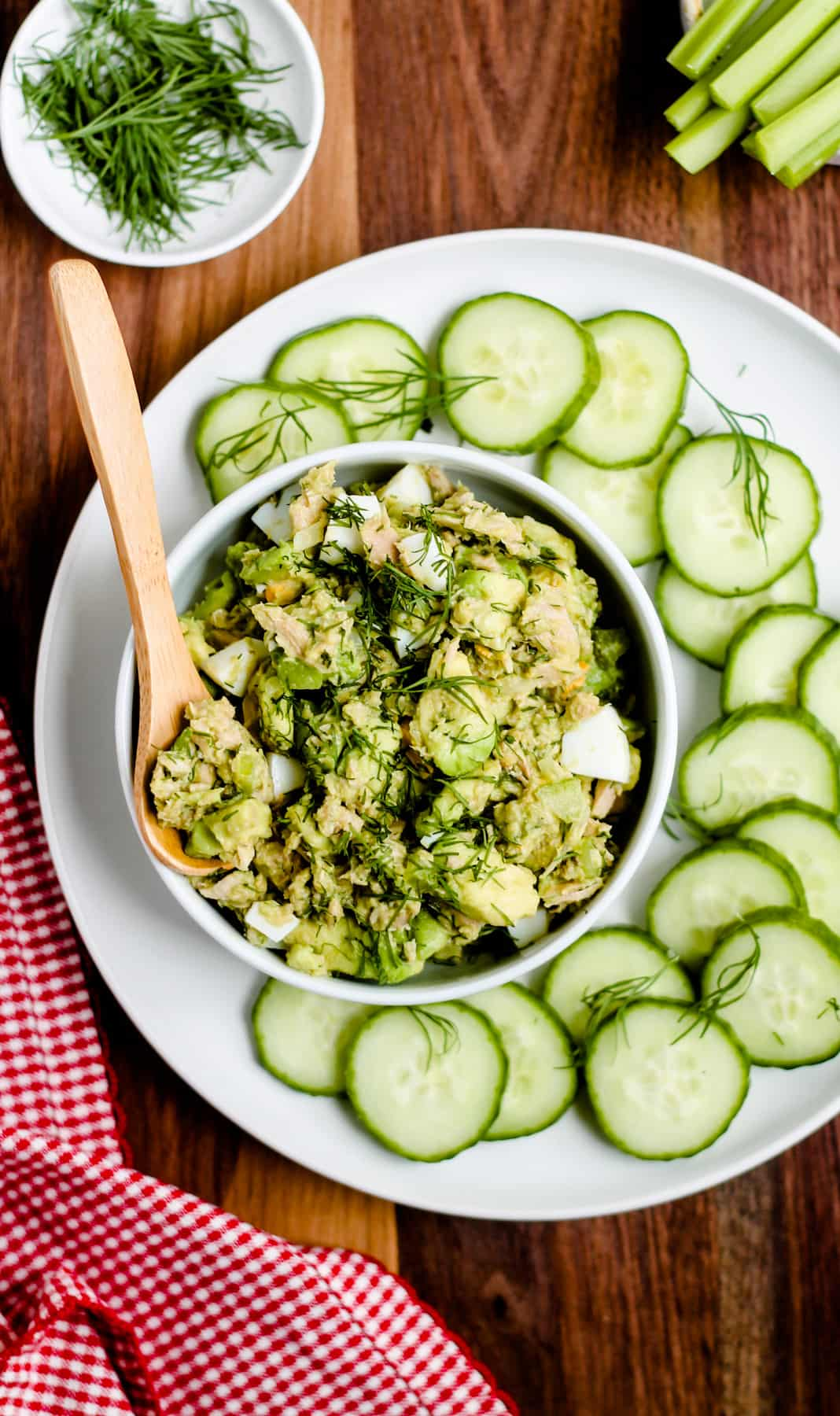 A spoon scooping out tuna and egg salad.