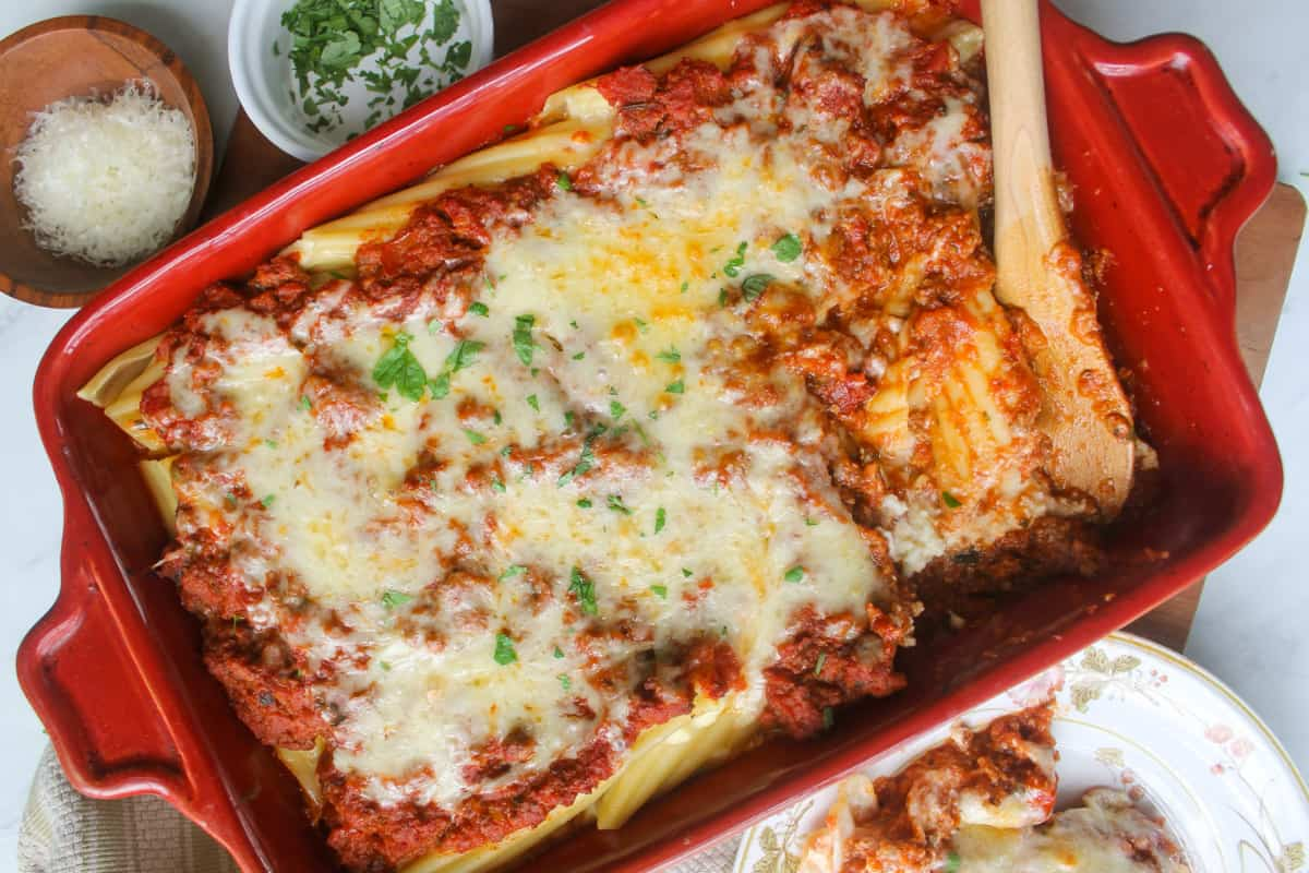 A pan of extra veggies manicotti with meat sauce.