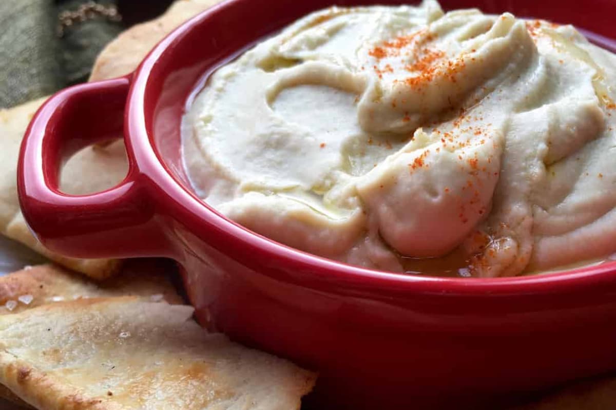 A bowl of white bean dip.