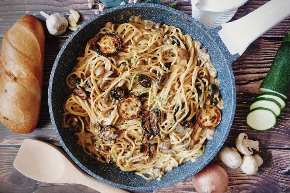 A skillet of zucchini mushroom pasta.