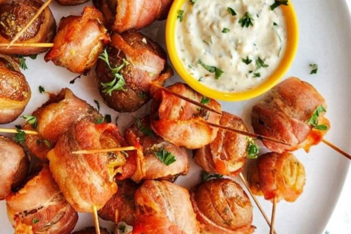 A plate of bacon wrapped potatoes.