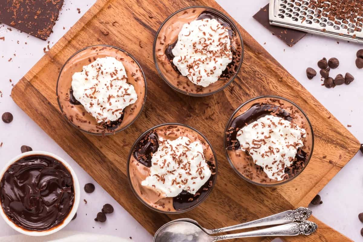 Four bowls of chocolate mousse.