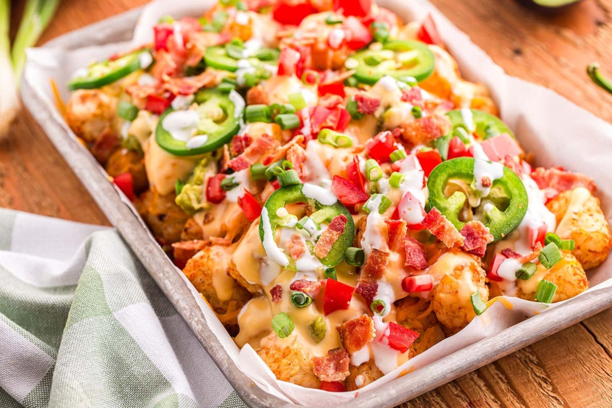 Loaded tater tots on a tray.