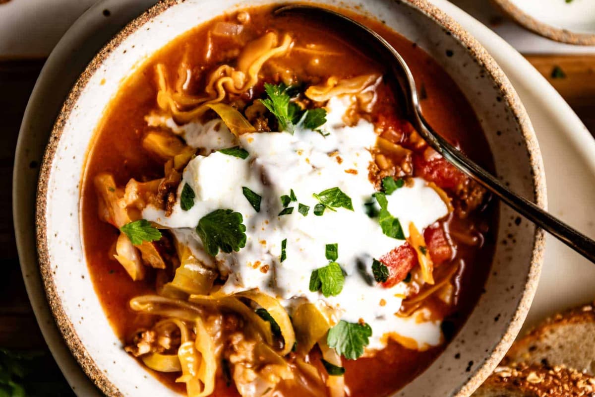 A bowl of stuffed cabbage rolls soup.