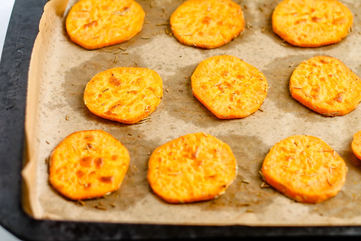 Roasted sweet potato slices on a baking sheet.