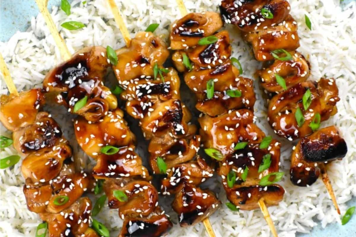 A plate of chicken teriyaki skewers.