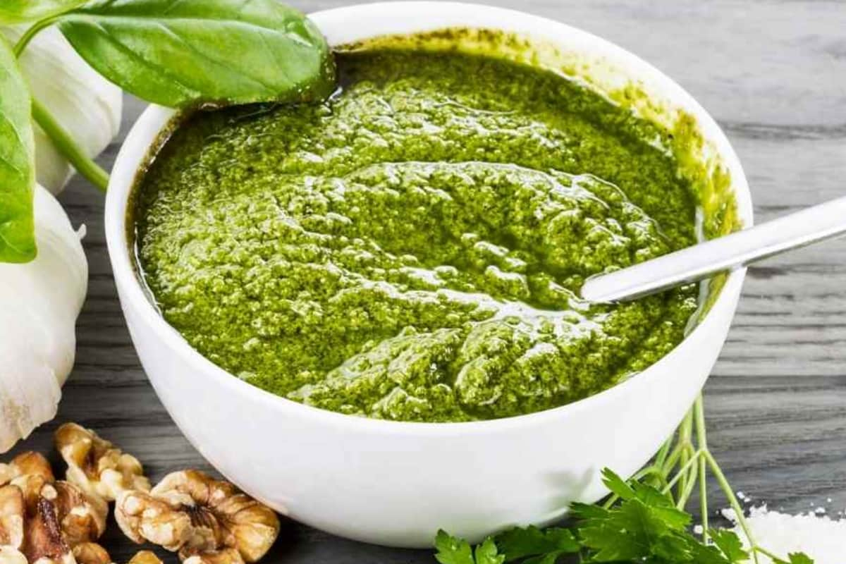 A bowl of basil pesto sauce.