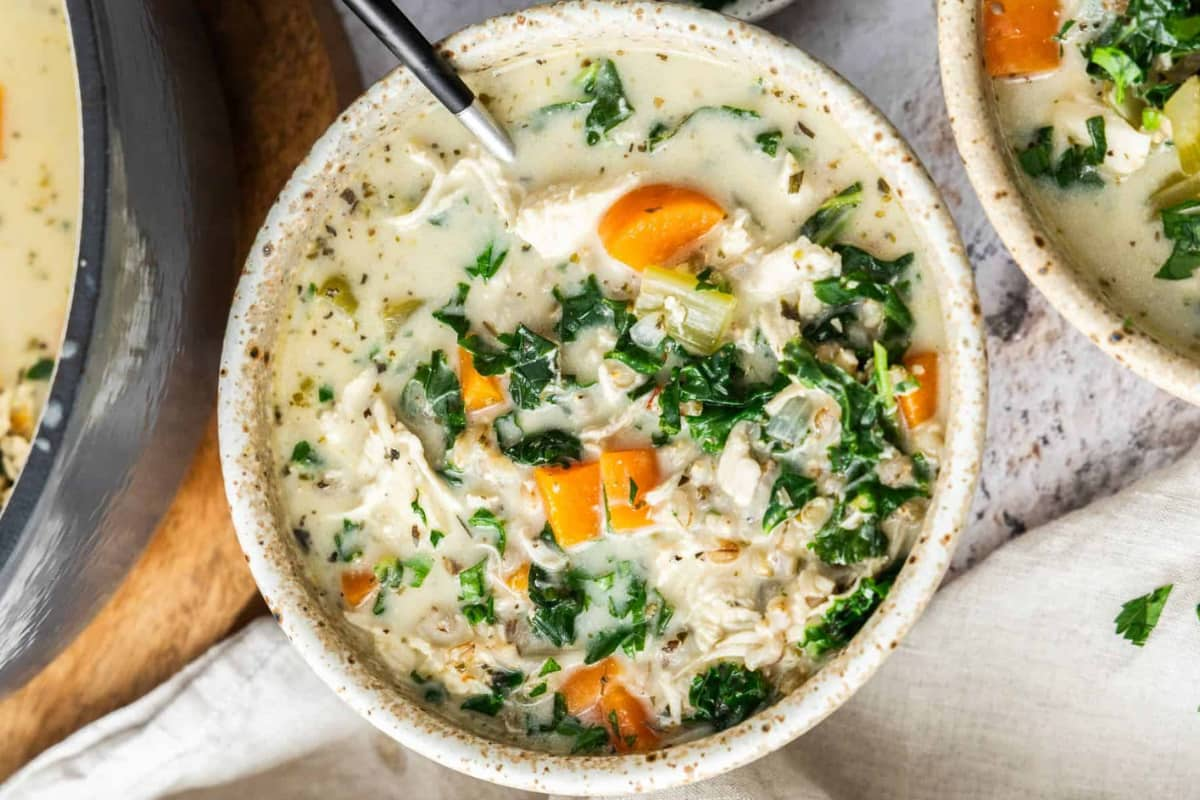 A bowl of creamy chicken barley soup.