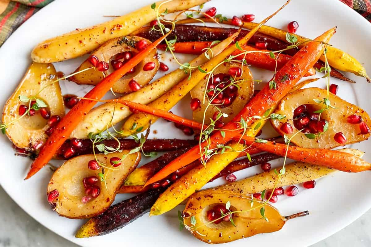 A platter of glazed carrots and pears.