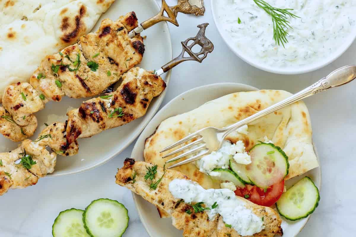 A plate of greek style chicken breast dinner.